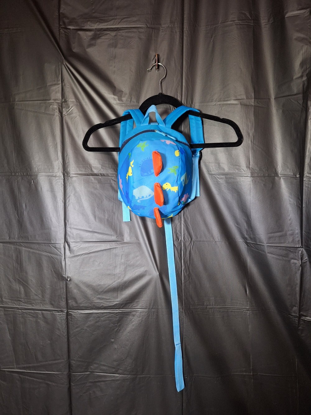 Kids Blue Dinosaur Backpack with Orange Spikes & Safety Leash.